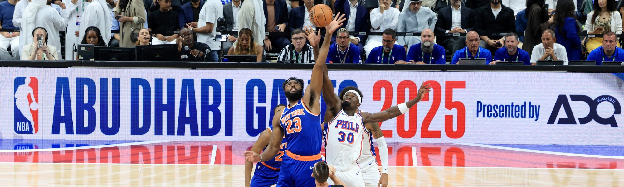 Basketball players competing for possession.